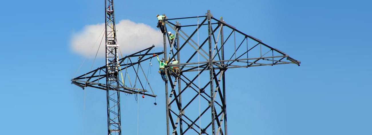 Lineworkers erecting new transmission tower